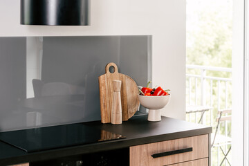 Modern kitchen with induction hob and electric stove in an apartment setting