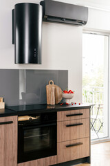 A modern setup with an induction hob and an electric stove