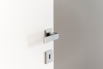 Sleek contemporary door handle with keyhole in apartment