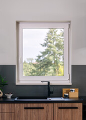 New modern kitchen interior with black sink and faucet