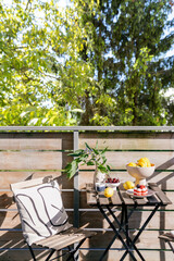 Bright balcony setting with fruit and flowers for morning relaxation