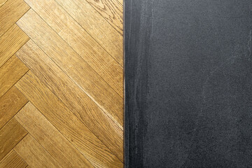 Residential floor with herringbone parquet and dark concrete surface