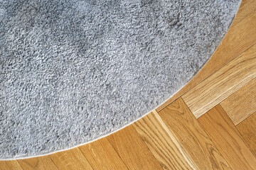 Living space with gray carpet and wooden parquet floor