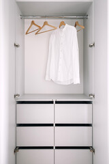 Neat storage cupboard with wardrobe space and organized shelves in apartment