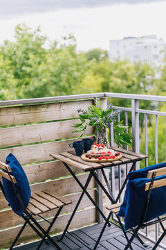 Cozy balcony setup with breakfast and views in an apartment during summer
