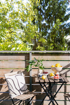 Bright balcony setting with fruit and flowers for morning relaxation