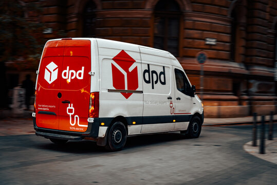 Branded cargo minibus on city street in motion