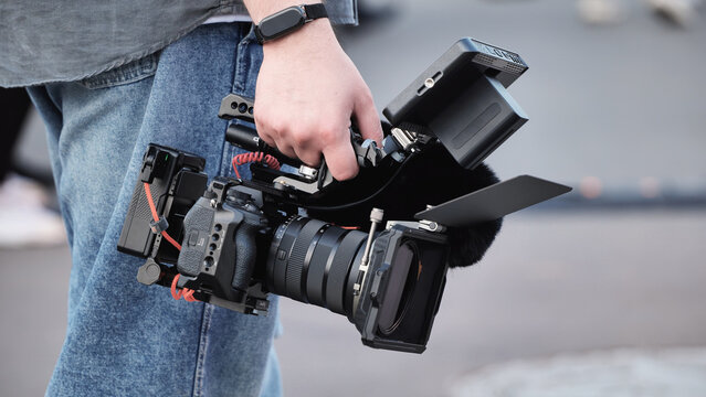 Handheld camera rig filming video production with professional cinematography gear