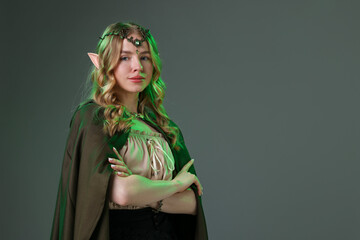 Obraz premium Beautiful girl dressed as elf on grey background, space for text