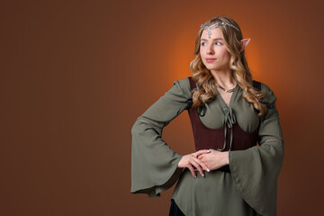 Obraz premium Portrait of beautiful elf girl on brown gradient background, space for text