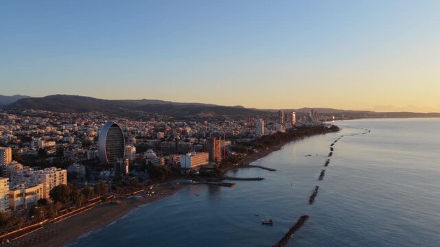 Aerial drone view of Limassol beachfront and urban skyline stretching along the Mediterranean coast