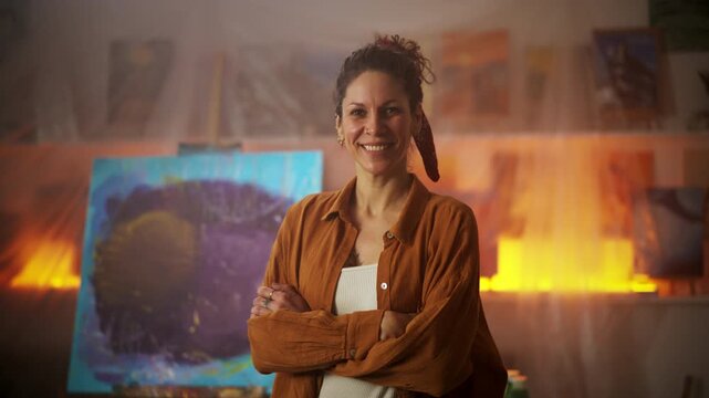 Portrait of Artist With Crossed Arms Stands Before Colorful Abstract Painting In Inspiring Studio Setting