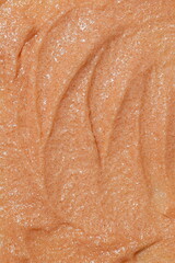 Fototapeta premium Close-up macro texture of shimmering beige cosmetic scrub with fine particles
