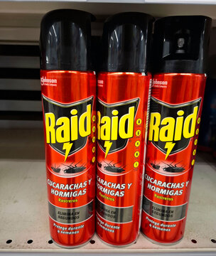 DENIA, SPAIN - December 10, 2025.Cans of Raid insecticide are lined up on a supermarket shelf in Spain showing their protection for cockroaches and ants