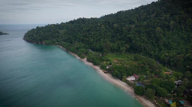 Aerial drone view of tropical beach, turquoise sea and lush green forest in Thailand. Stunning natural coastal landscape, untouched paradise with clear water and scenic shoreline.