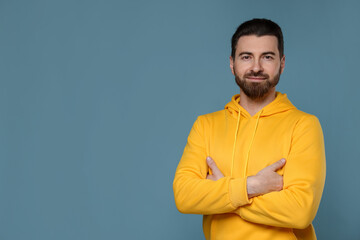 Fototapeta premium Portrait of handsome man on light blue background, space for text