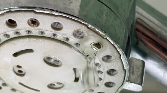 Mineral deposits clogging metallic bath slow motion