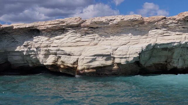 Aerial drone view of white cliffs meeting turquoise water near Ayia Napa, Cyprus