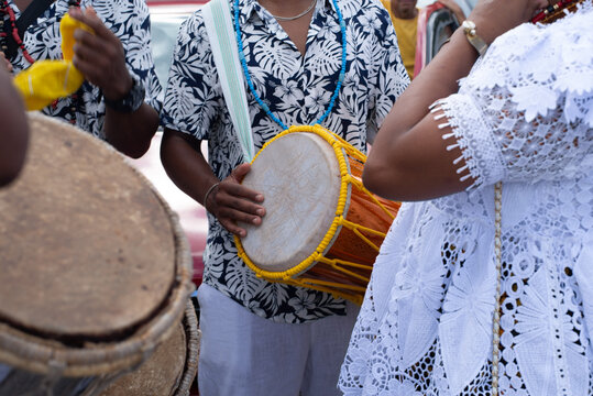 Musician playing atabaque in procession