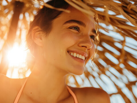 Close up playful portrait of a smiling woman relaxing in the sun during a playful summer vacation