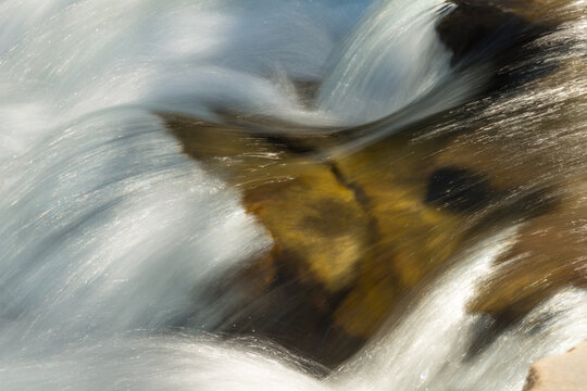 Canada, Alberta, Calgary.  Fresh, mountain water rushing over rocks in the Sheep River Falls.  Sheep River Provincial Park.