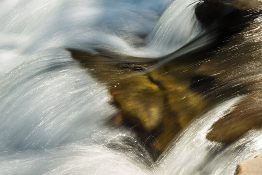 Canada, Alberta, Calgary.  Fresh, mountain water rushing over rocks in the Sheep River Falls.  Sheep River Provincial Park.