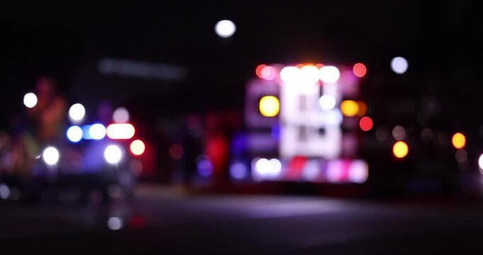 Night time abstracted view of an ambulance unit responding to the scene of an emergency.
