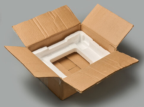 empty open brown cardboard box with styrofoam isolated grey background, container with white polystyrene protective insert, mock-up template