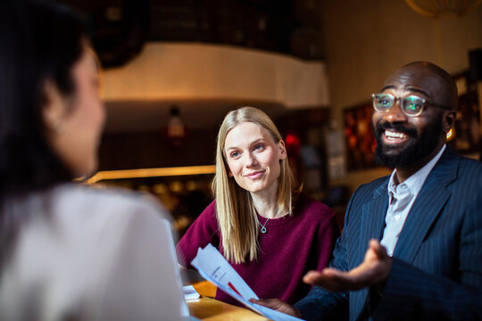 Clients meeting with advisor in modern cafe