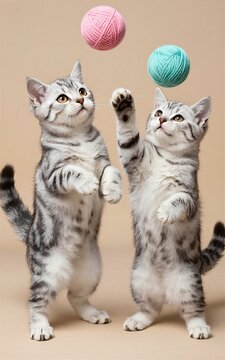 Two playful kittens leap after colorful yarn balls in a whimsical