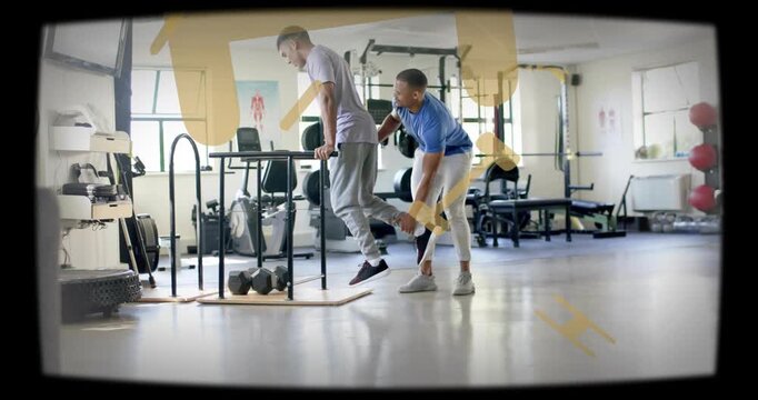 Stepping coach spotting client in purple doing one-leg dip at parallel bar holding foot for balance