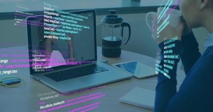 Holding mug, navy-sweater woman sipping while viewing laptop code overlay at desk, copy space