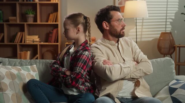 Caucasian family problem quarrel offended father daughter crossed hands ignoring conflict dad man male child kid little girl upset avoid pushing at home living room bad relationship custody trouble