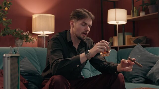 Depressed angry Caucasian male gambler smoking cigar throwing poker card losing casino game mad gamer man guy playing wager lost failure bet drink whiskey unhealthy habit alcoholism gambling at home