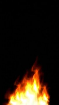 A blazing fire burns brightly in the darkness of night, with flames reaching upwards and stars shining in the background, possibly used for dramatic or symbolic purposes