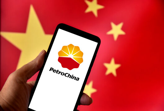 PetroChina logo on a smartphone screen with the Chinese flag in the background. PetroChina is the largest oil company in China and the largest in the world by market capitalization.