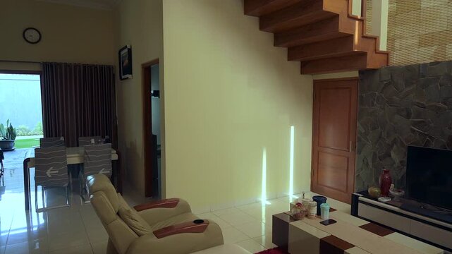 Modern living room with stone wall, flat tv and bright furniture decoration