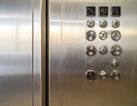 A close-up of an elevator's control panel with buttons
