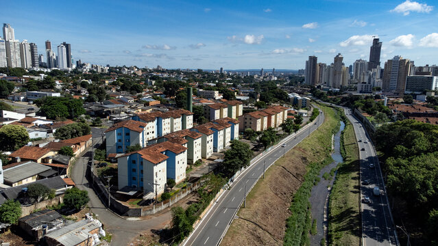 High angle aerial view showing the Marginal Botafogo expressway with residential apartment blocks in Pedro Ludovico and the skyscrapers of Jardim Goias and Setor Bueno in Goiania, Brazil.