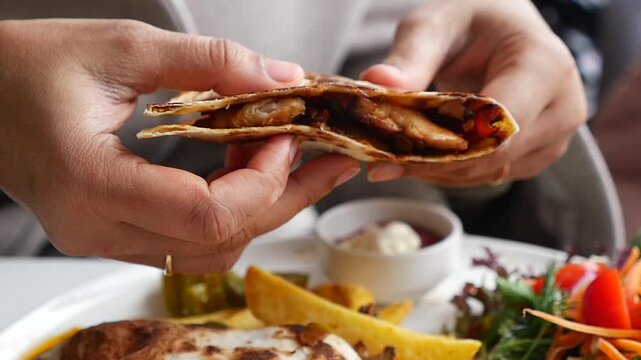 Enjoying a delicious wrap with chicken and vegetables