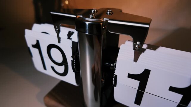 A beautifully crafted desktop flip clock in slow motion.