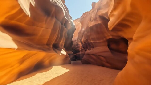 A serene desert canyon with smooth, sandstone walls and a sandy path