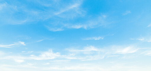 Obraz premium the sky is clear blue with fluffy white clouds, the sky is very bright, and the sun shines.