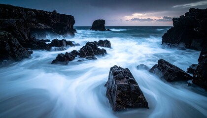 Fototapeta premium Dramatic long exposure captures ocean waves crashing against rugged volcanic rocks at dusk.