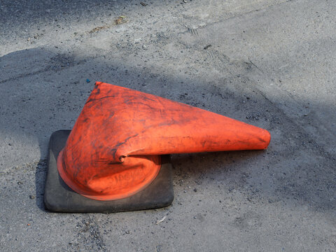A squashed  orange traffic cone