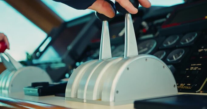 Hands Operating Yacht Throttle in Cockpit