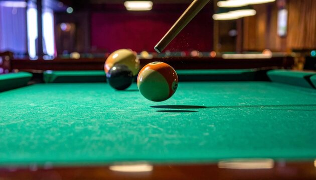 Precision Pool Shot - Striking the Ball with Cue Stick on Green Table.
