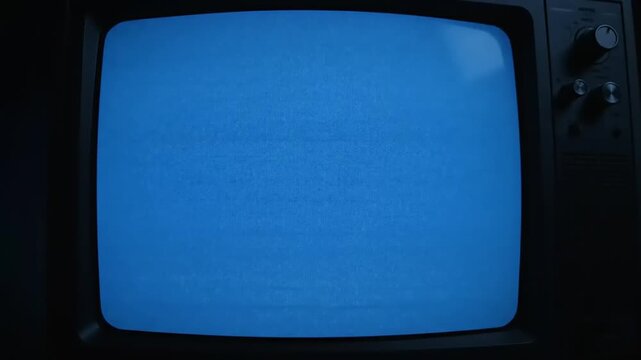 Old Analog CRT Television Set Turning On with Blue Screen Static Noise in a Dark Room