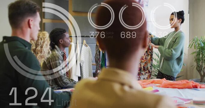 Vertical video: Walking presenter in cardigan lifting print dress at studio for review, team noting