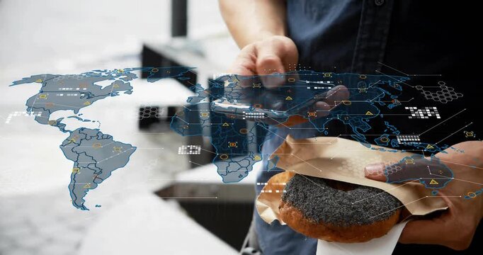 Mid-adult Asian man holding poppyseed pastry, lifting phone, tapping, revealing map HUD data